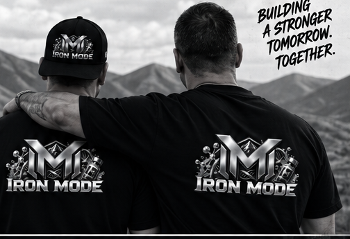 Two people wearing Iron Mode shirts looking out at the mountains — building a stronger tomorrow together
